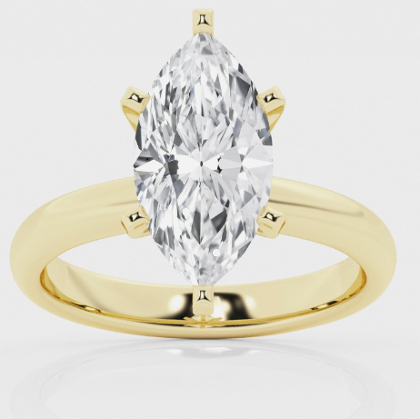 14 Karat Yellow Gold Diamond Solitaire Ring  Four Prong Set In A White Gold Center Is One Marquise Cut Diamond Weighing .58 Carat And Graded SI1 L.